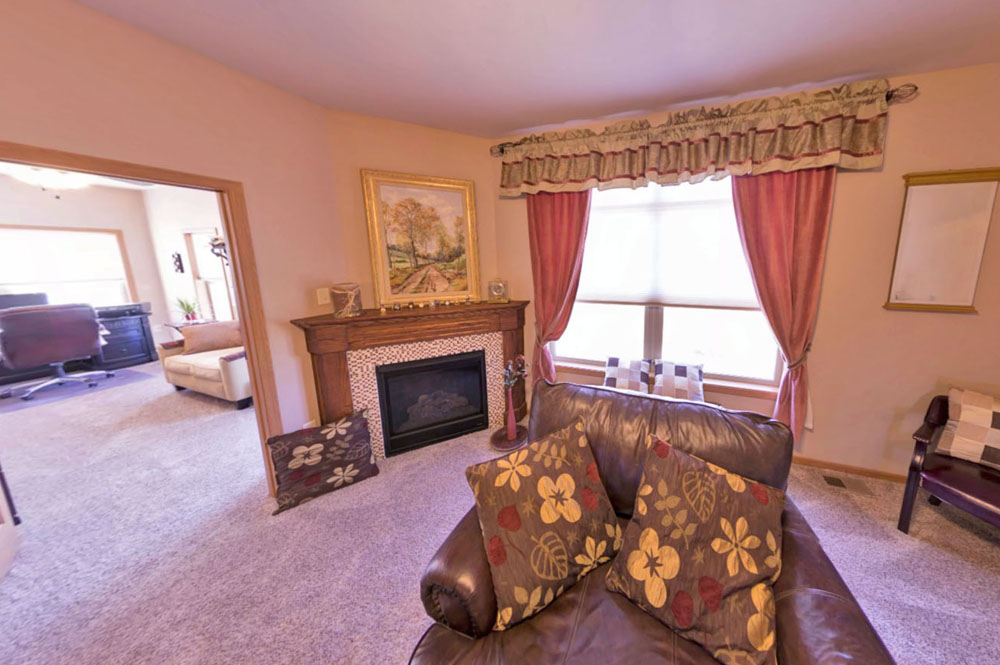 Townhome villa interior fireplace and four season sunroom at Primrose Retirement in Aberdeen, SD