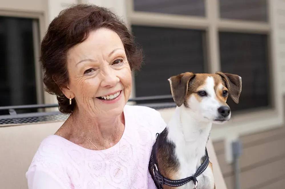 Senior independent living resident with her dog on her lap