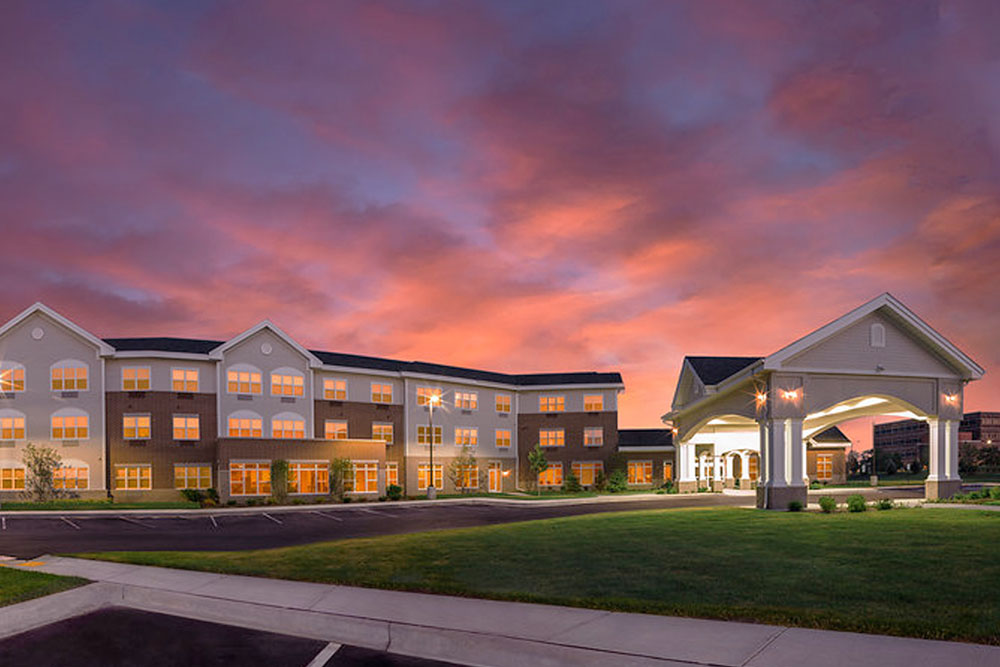 Front exterior of the Pleasant Prairie, WI Primrose Retirement Community at sunset.
