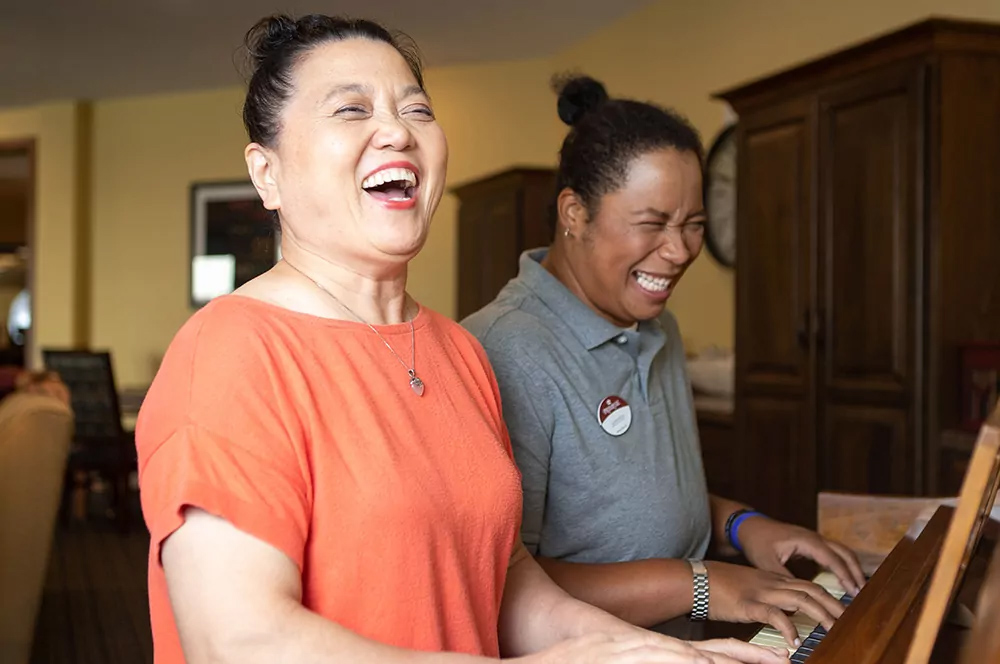 two women playing piano