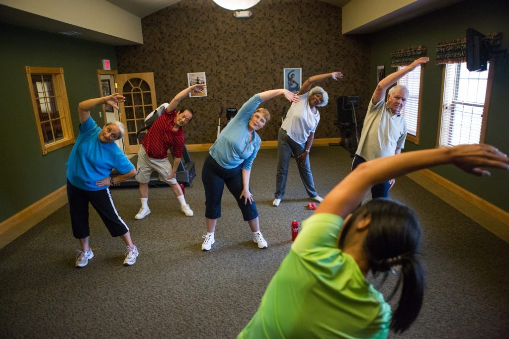 Residents stretching during senior living activities