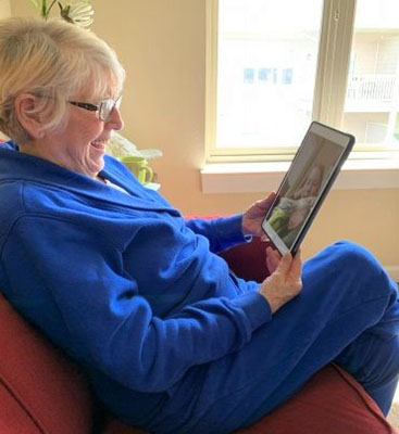 Senior woman talking to someone on an iPad