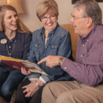 Senior couple talking with sales director about senior living finance options