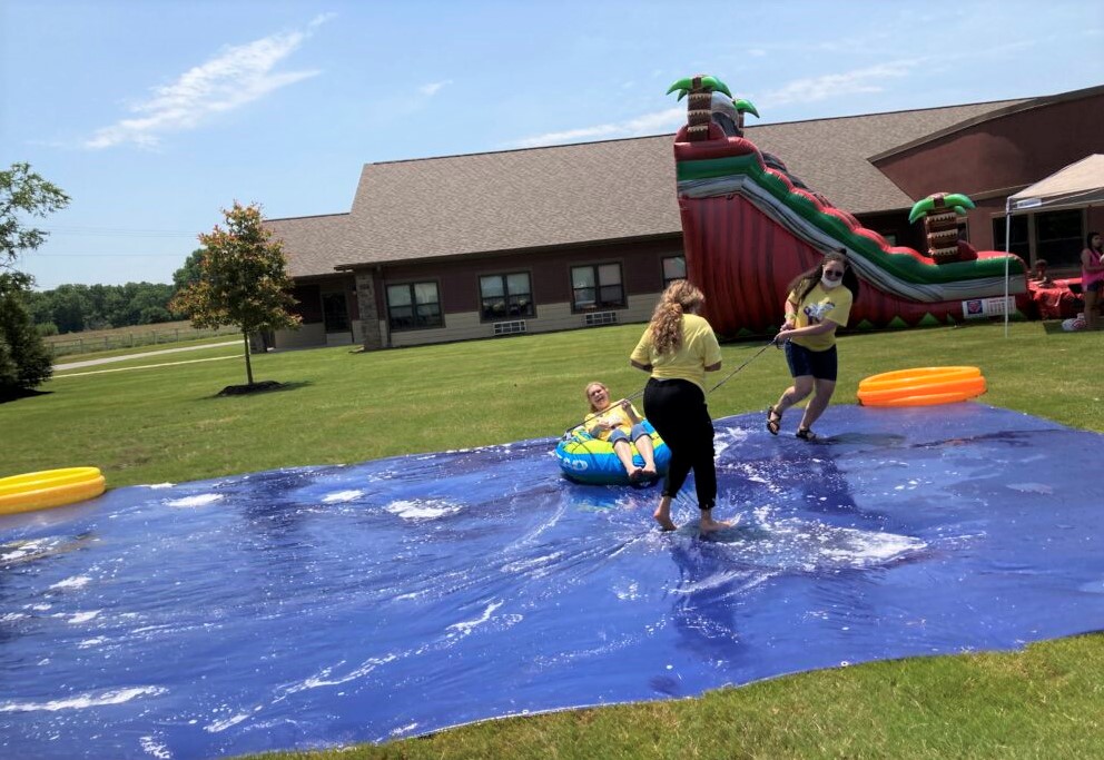 Primrose staff playing waterslide activities on Alzheimer's longest day event.
