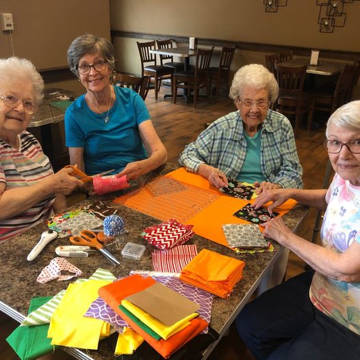 A group of senior women creating art during arts and craft activity.