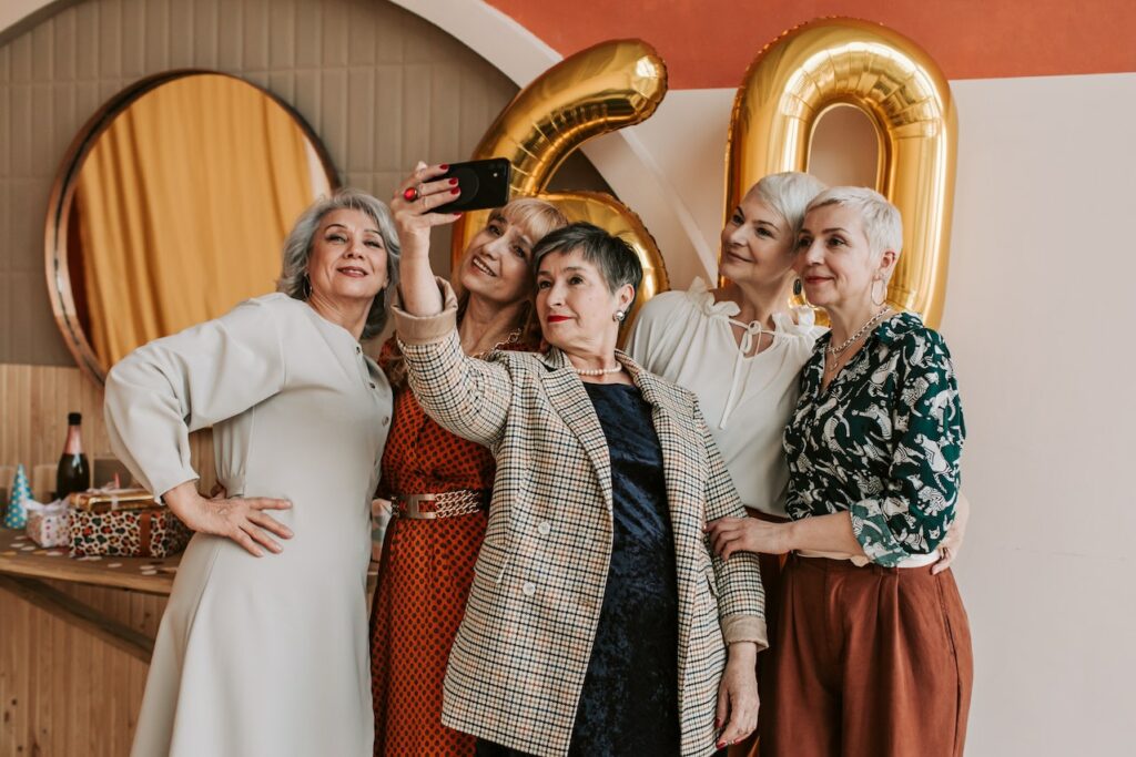 Group of senior woman posing for birthday photo.