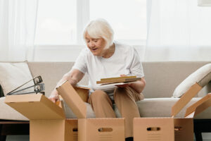senior woman packing boxes to move