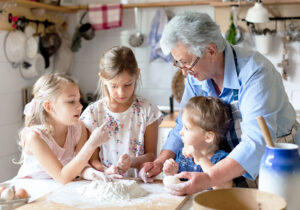 Grandmother baking with grandchildren in the kitchen