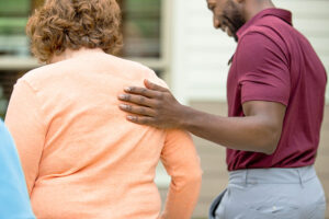 Staff member comforting senior resident