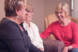 Three senior women sharing thoughts during book club