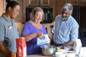 Residents and staff member take time to make fresh baked cookies together.