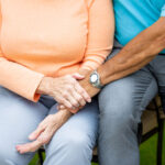 Senior couple holding hands on visit at Primrose Retirement Community