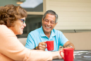 Senior couple having coffee together outdoors